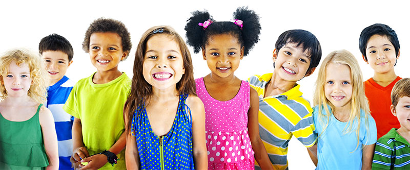 The image depicts a group of children with diverse skin tones and attire, posing together for a photo with smiles on their faces.