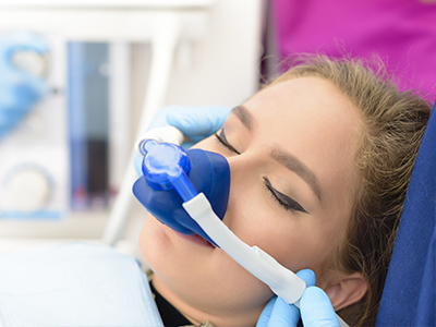 A person receiving oxygen therapy with a mask over their nose and mouth.